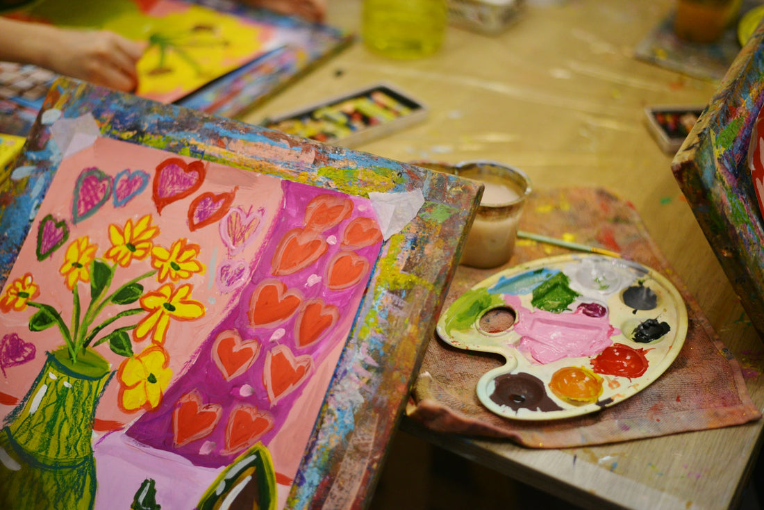 a table topped with lots of art supplies