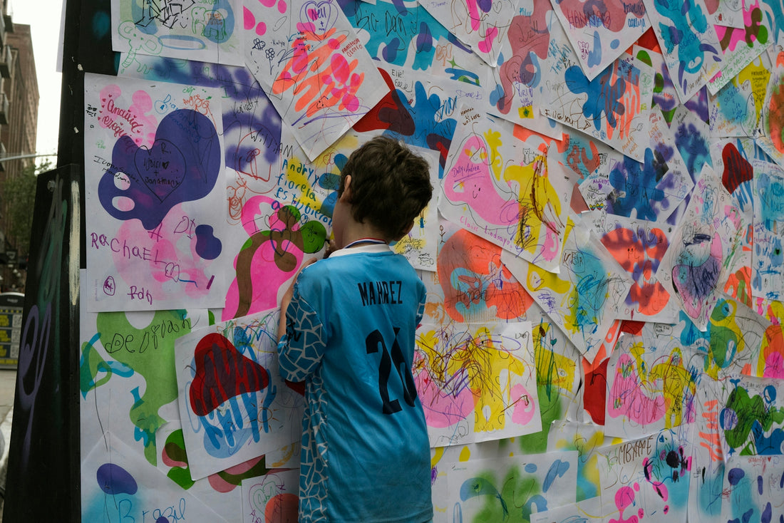 A child admiring colorful artwork on a wall