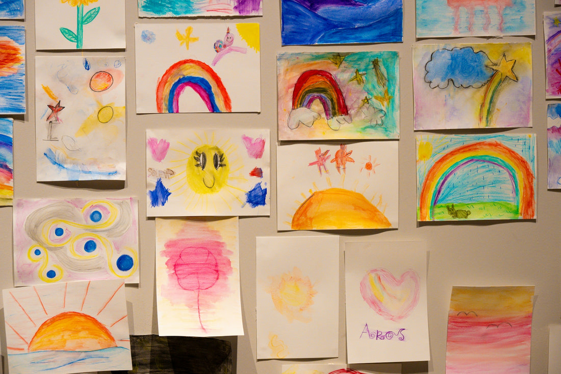 Collection of colorful children's drawings on a wall